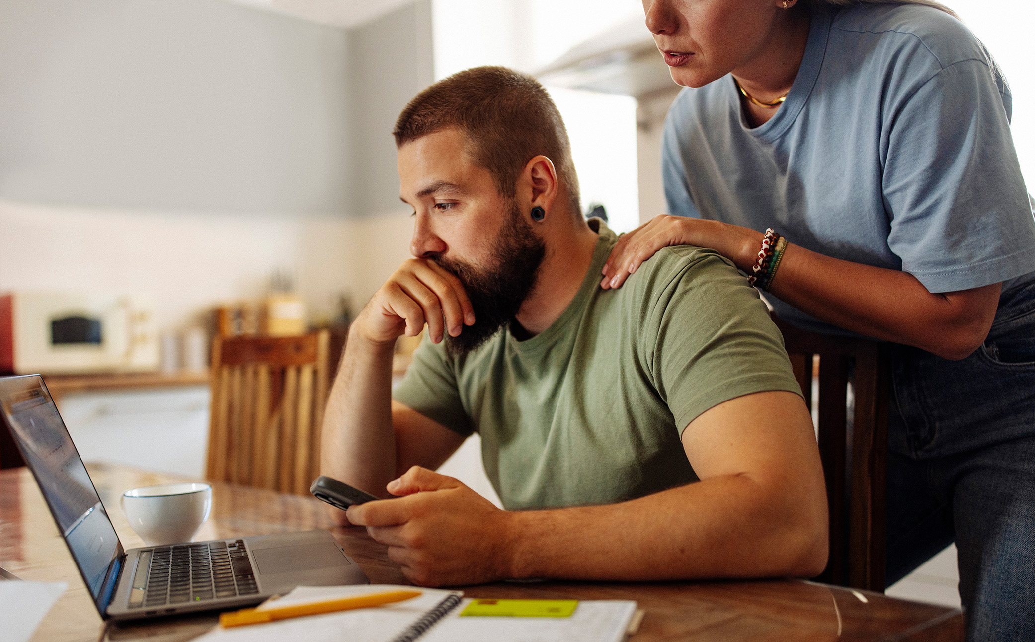 Man upset, consoled by partner.